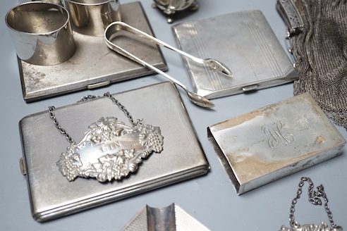 Sundry small silver including three silver cigarette cases, ashtray, three napkins rings, match sleeve, wine labels, pepper, gross and a white metal mesh evening bag.